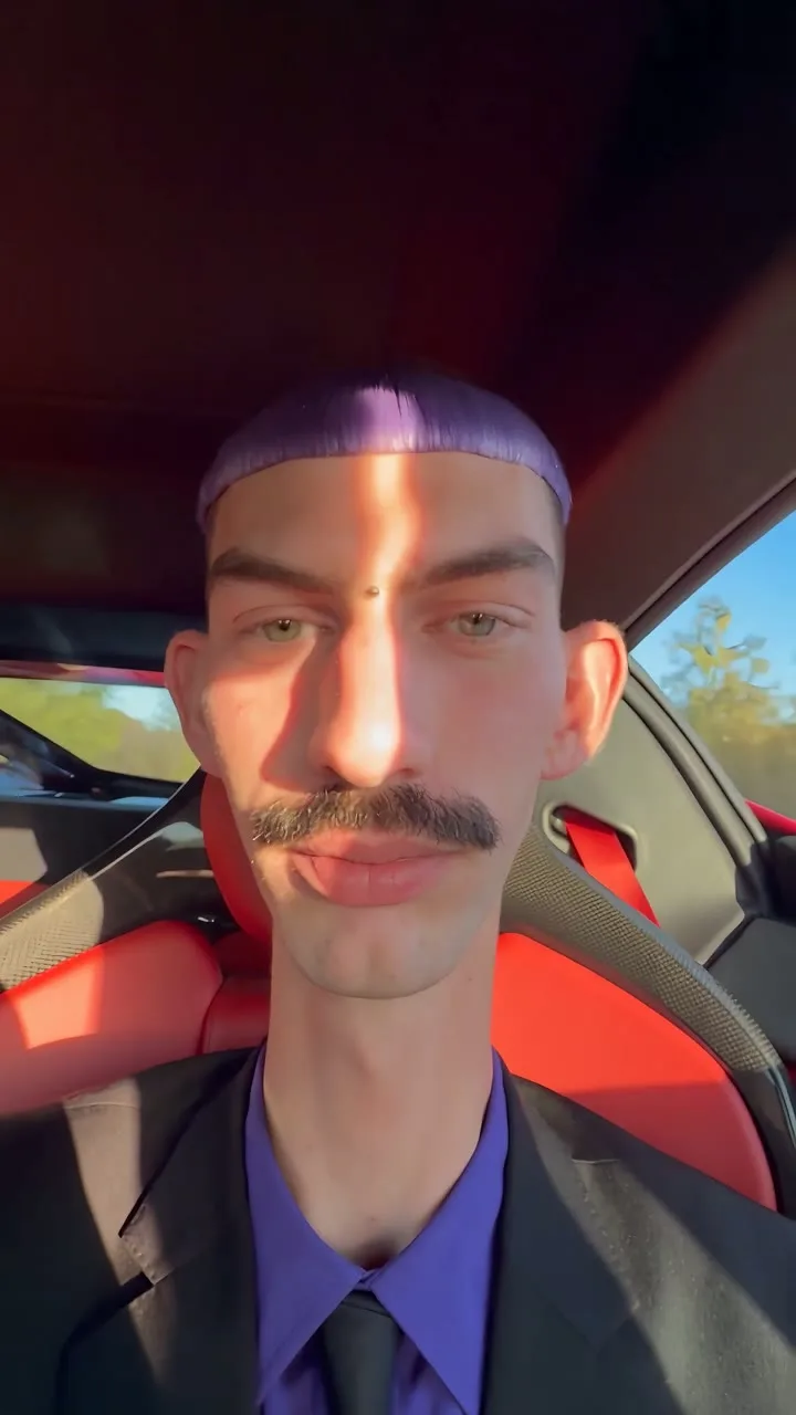 C talking inside a red sports car